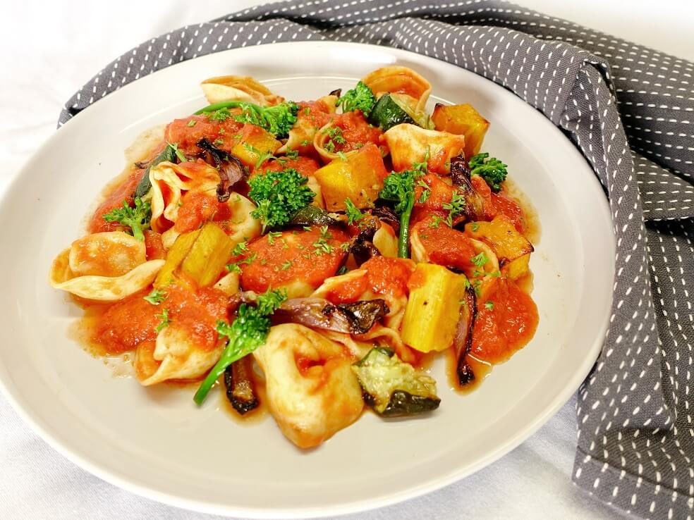 Spinach and ricotta tortellini with roasted vegetables in creamy red ...